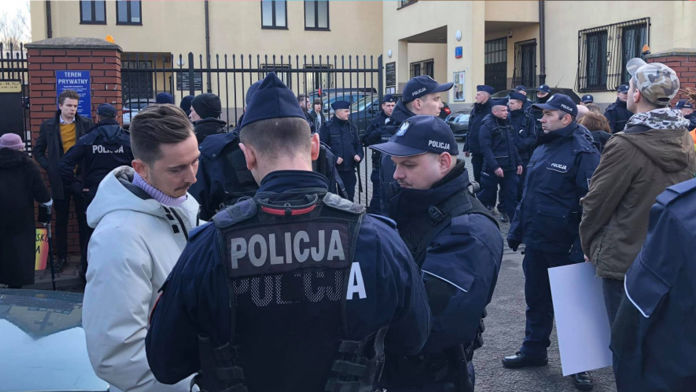Inclusion without borders image. Image of Martin Kmiecik being questioned by the police at an LGBTQ protest in Poland